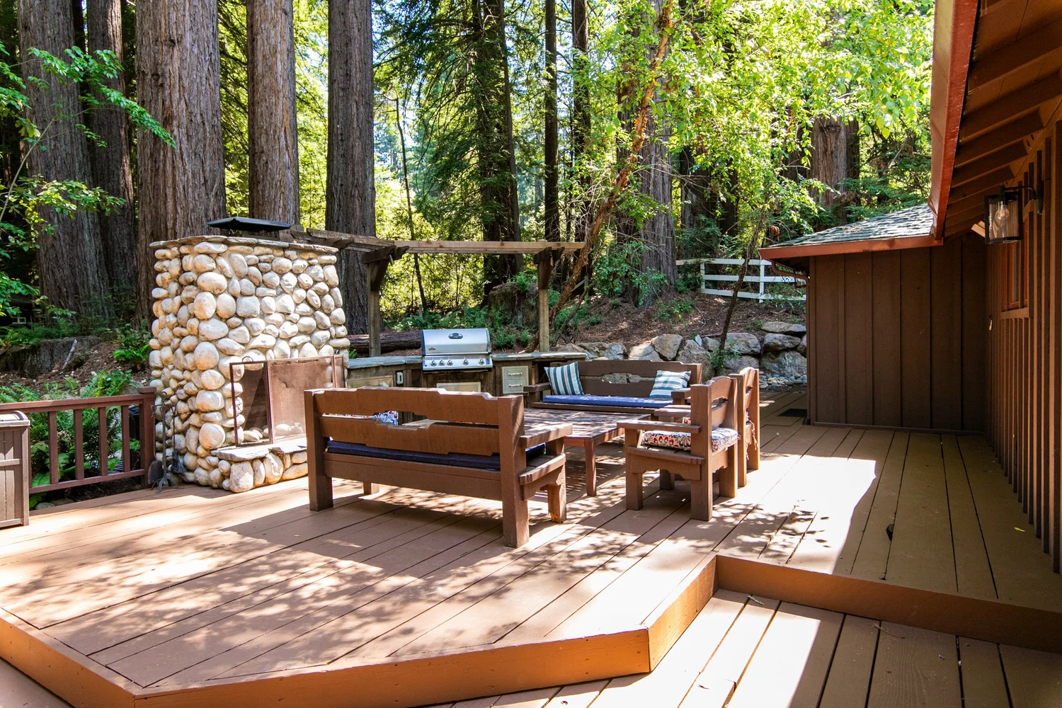 Redwood deck lounge with stone fireplace